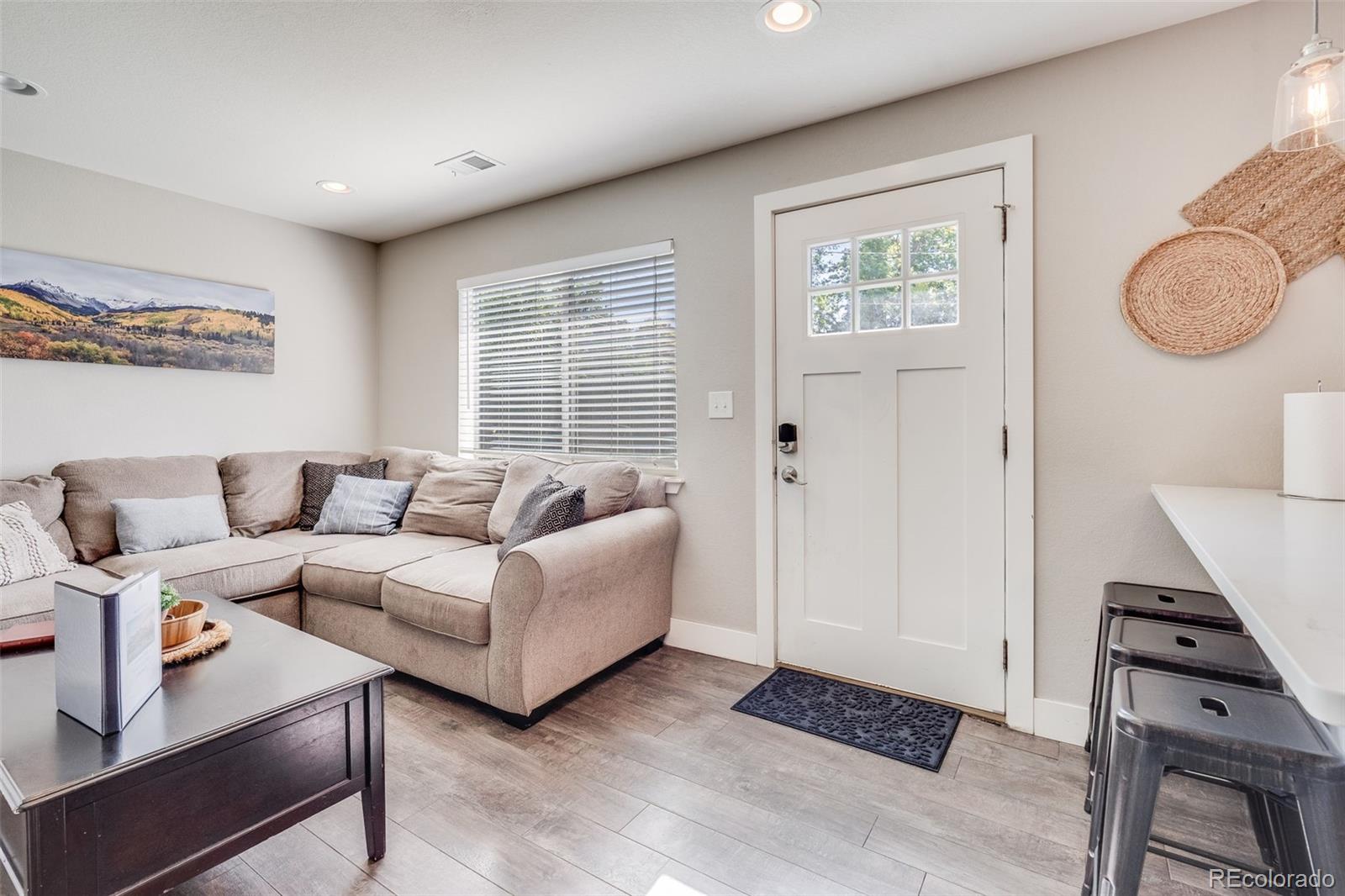 5240 Stuart Street Denver, CO 80212 - Photo 23 of 42 a living room with furniture and a window
