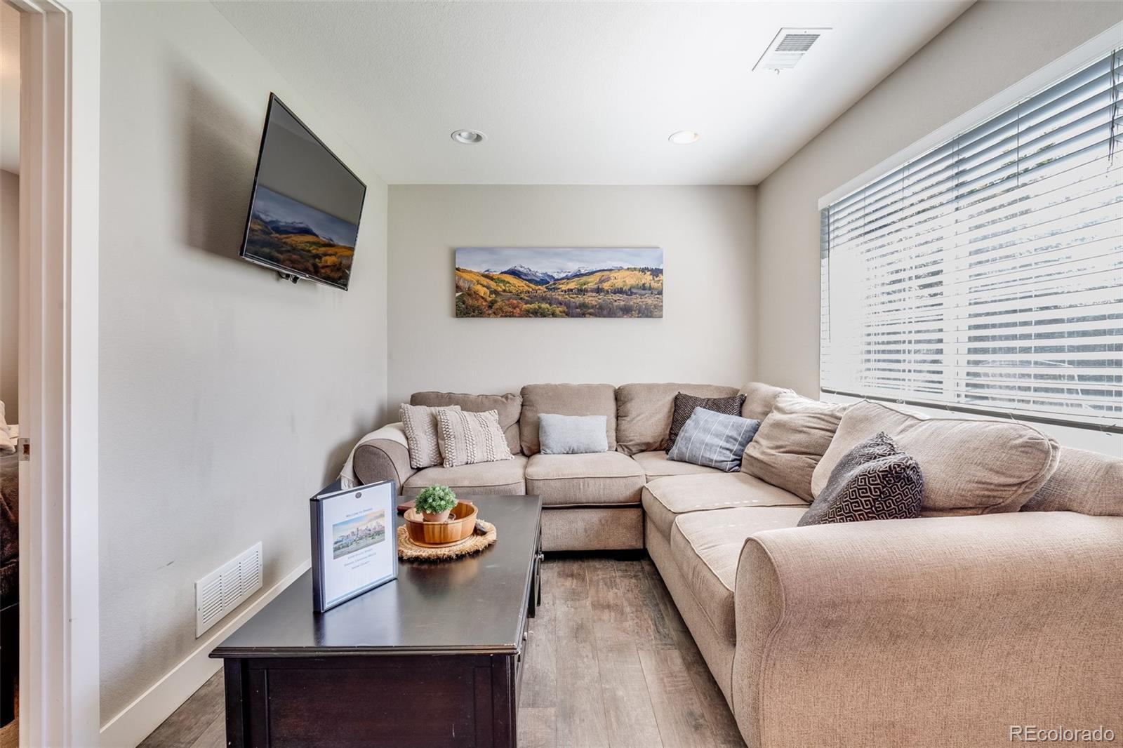 5240 Stuart Street Denver, CO 80212 - Photo 24 of 42 a living room with furniture and a flat screen tv