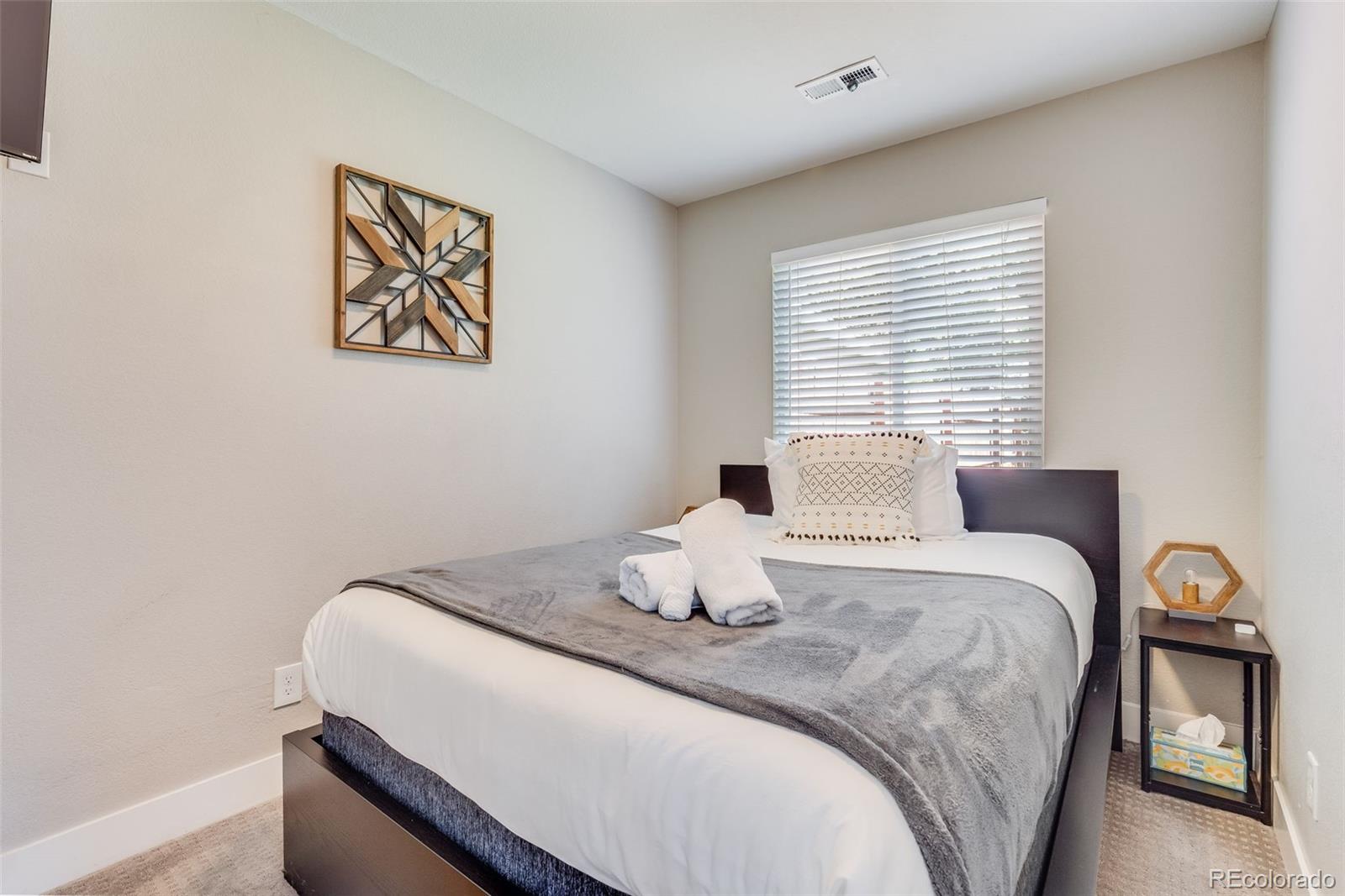 5240 Stuart Street Denver, CO 80212 - Photo 28 of 42 a bedroom with a bed and a lamp