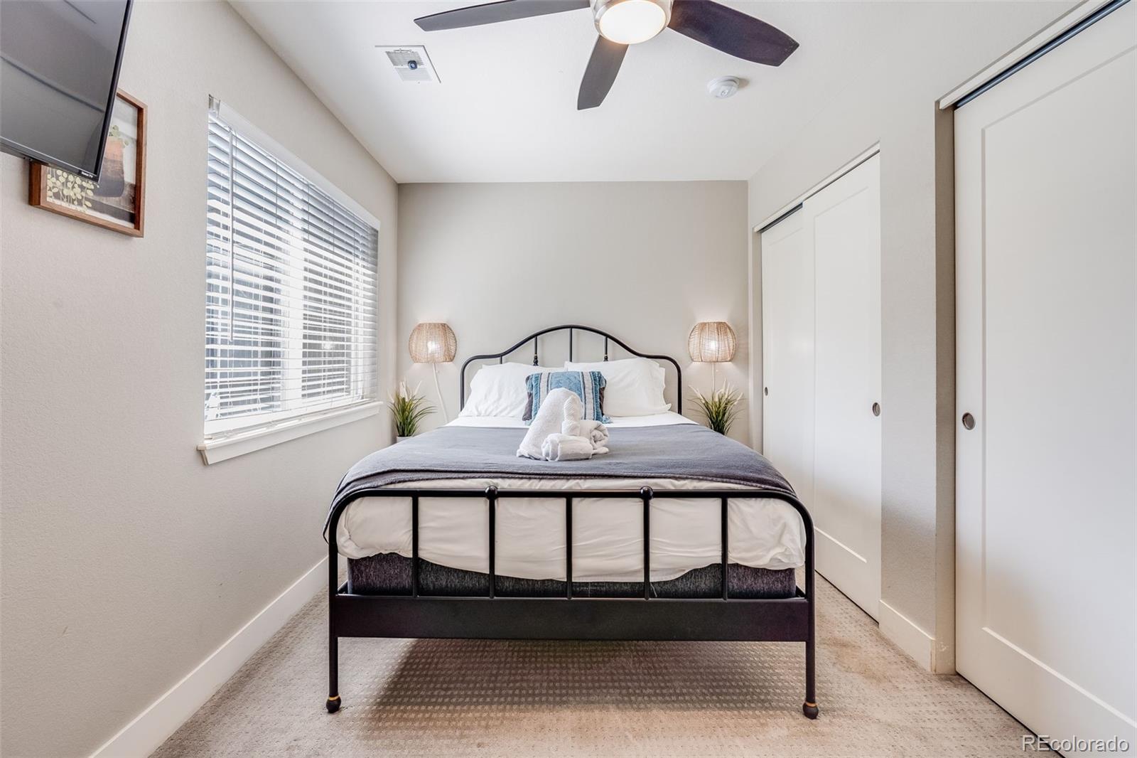 5240 Stuart Street Denver, CO 80212 - Photo 30 of 42 a bedroom with a bed and window