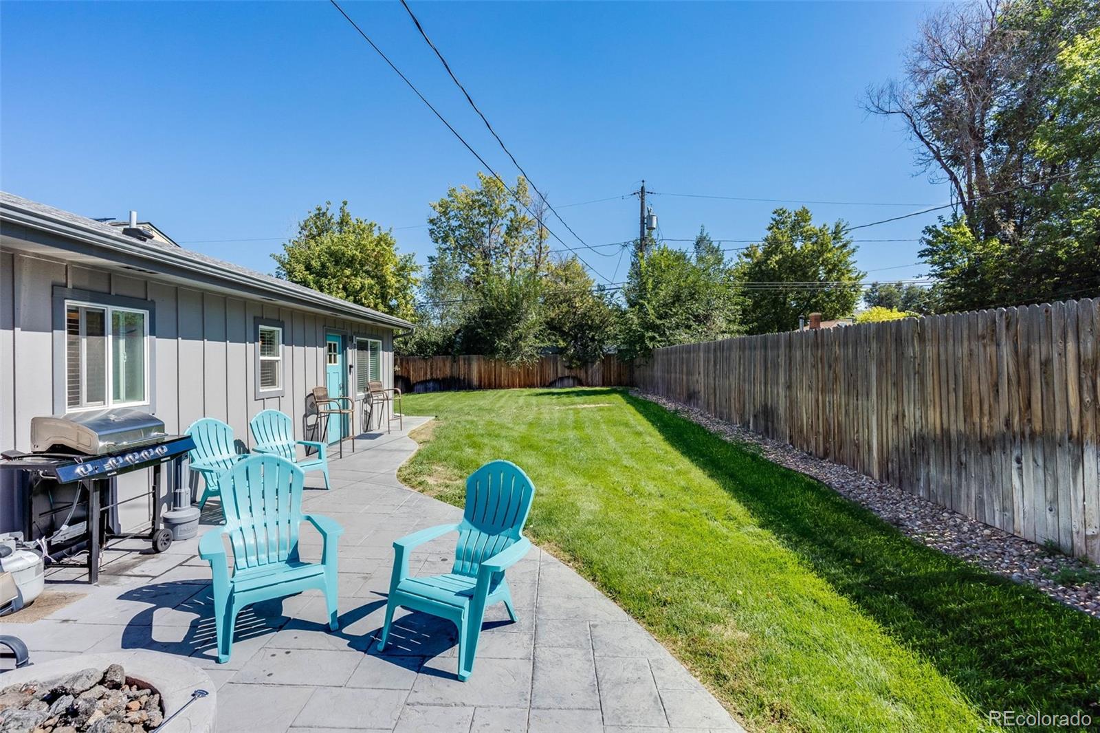 5240 Stuart Street Denver, CO 80212 - Photo 32 of 42 a view of backyard with seating space and trees in the background
