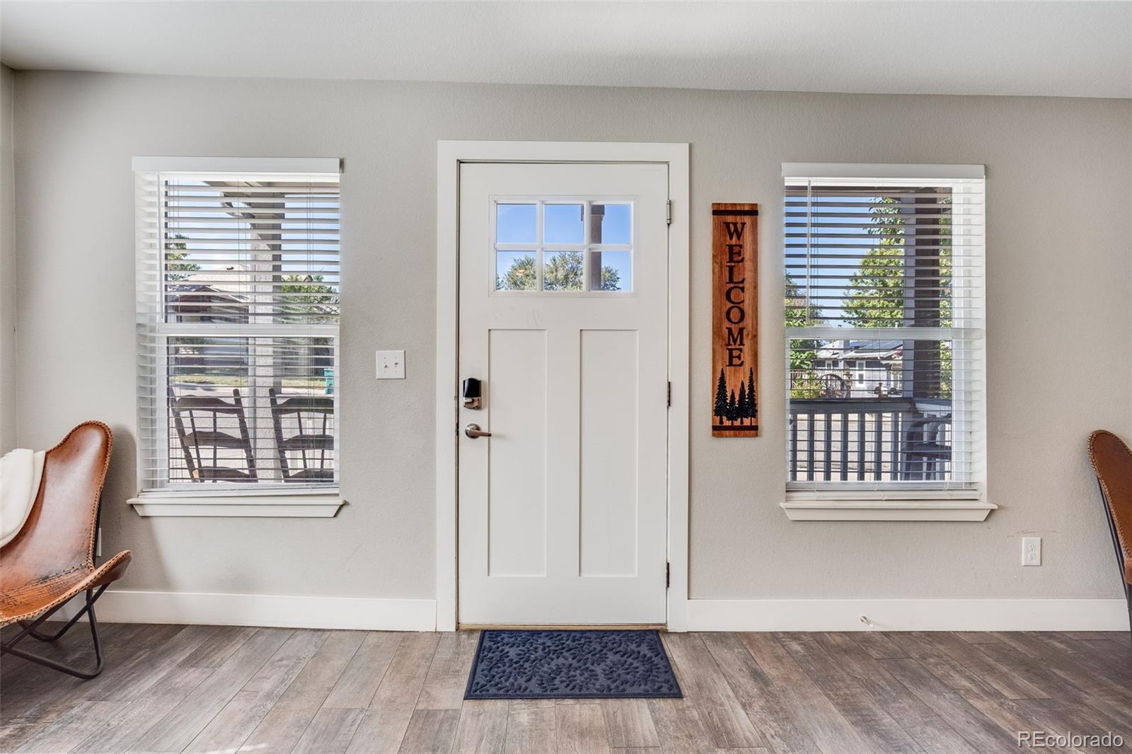 5240 Stuart Street Denver, CO 80212 - Photo 5 of 42 a view of a bedroom with a window and wooden floor