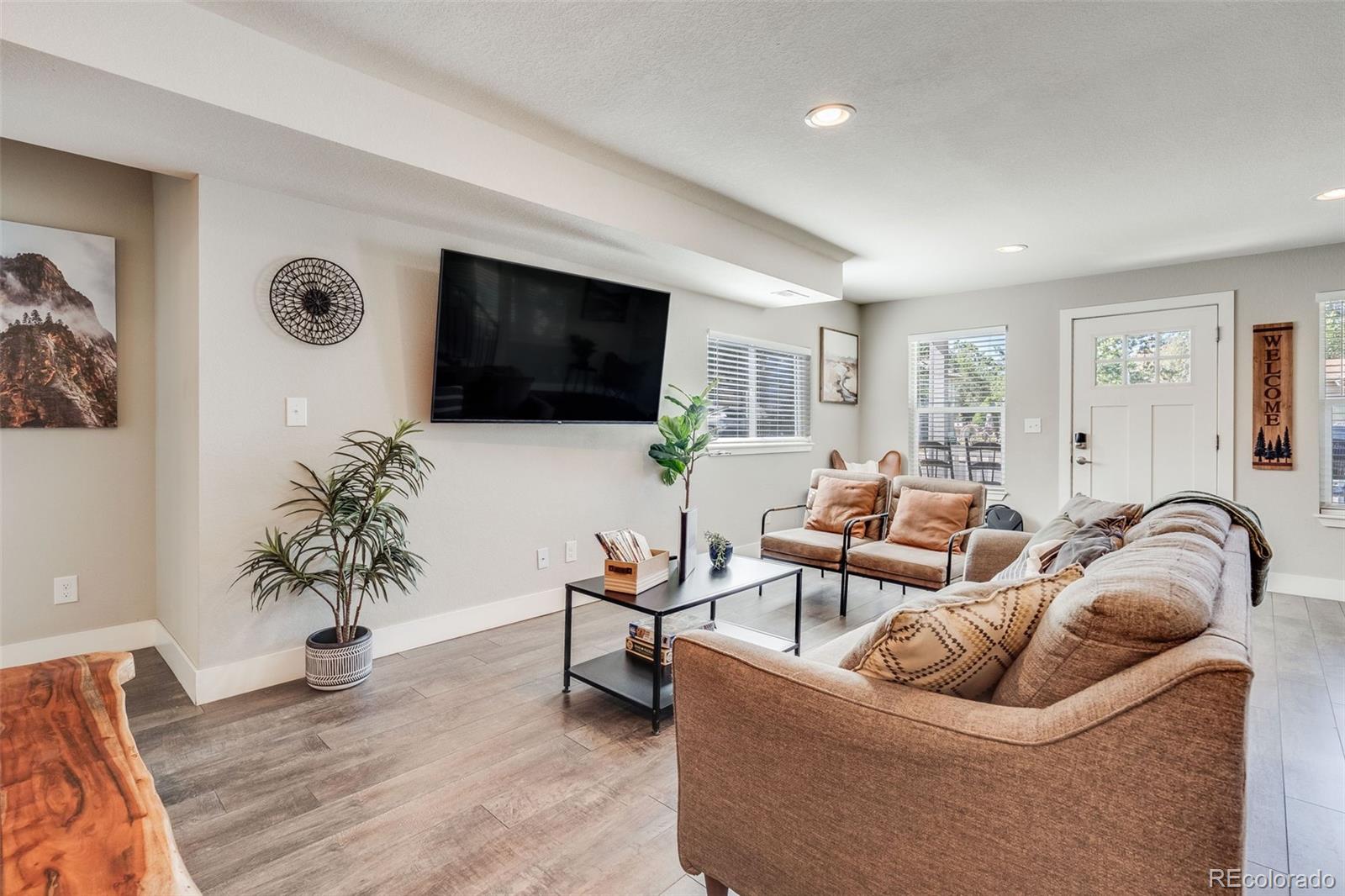 5240 Stuart Street Denver, CO 80212 - Photo 6 of 42 a living room with furniture and a flat screen tv