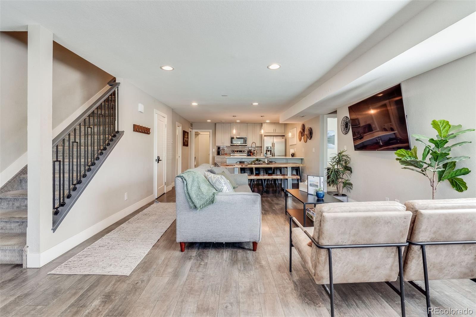 5240 Stuart Street Denver, CO 80212 - Photo 9 of 42 a living room with furniture and a flat screen tv
