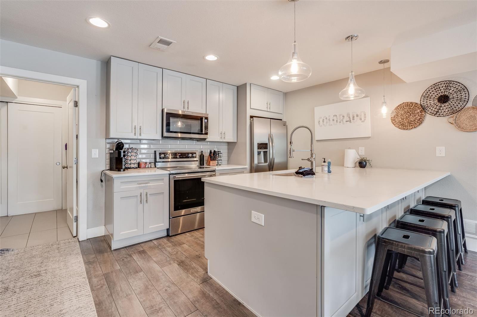 5240 Stuart Street Denver, CO 80212 - Photo 10 of 42 a kitchen with a sink a stove a refrigerator and a refrigerator