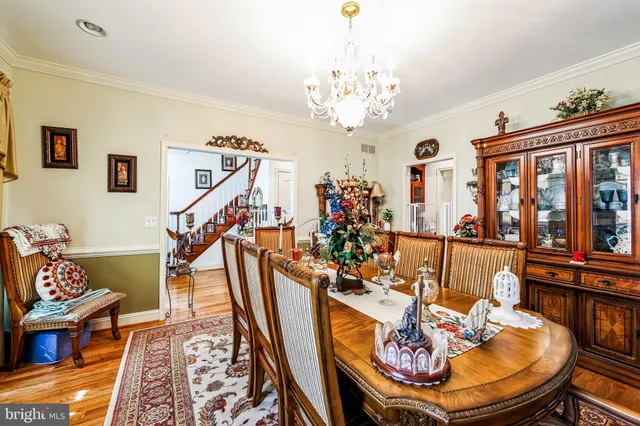 a view of a hallway with a dining table and chairs