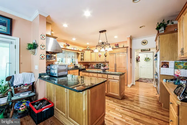 a dining room filled chandelier and wooden floor
