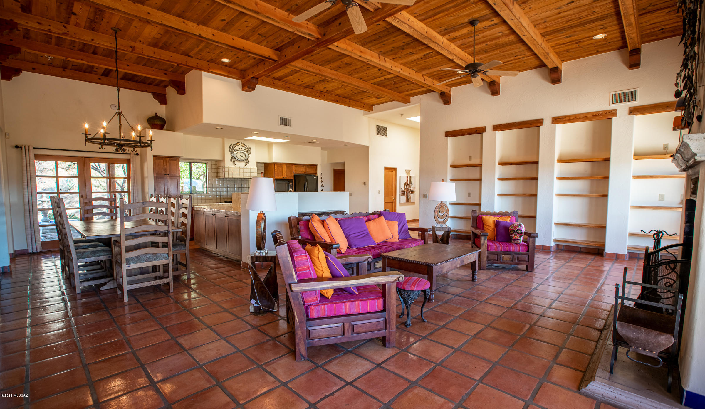 1551 Vía San Cayetano Rio Rico, AZ 85648 - Photo 16 of 29 a living room with lots of furniture and a chandelier