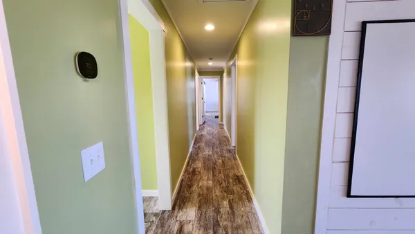 a kitchen with granite countertop a stove a sink and wooden floor