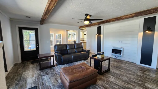 a living room with furniture and a large window