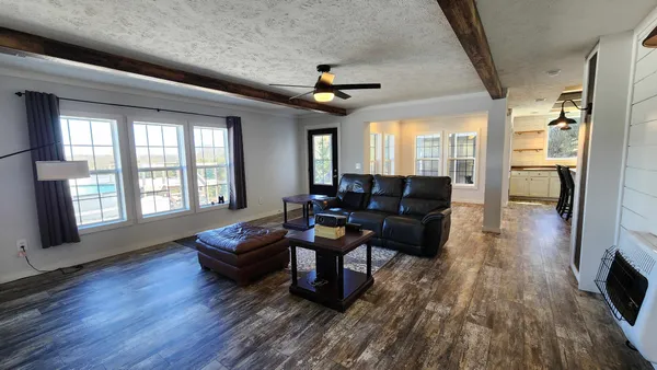 a view of roof deck with chairs and wooden fence