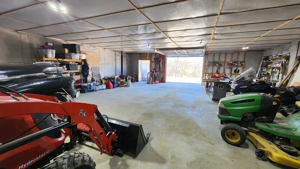 a view of a dry yard with trees