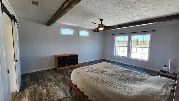 a workspace with wooden floor and a window