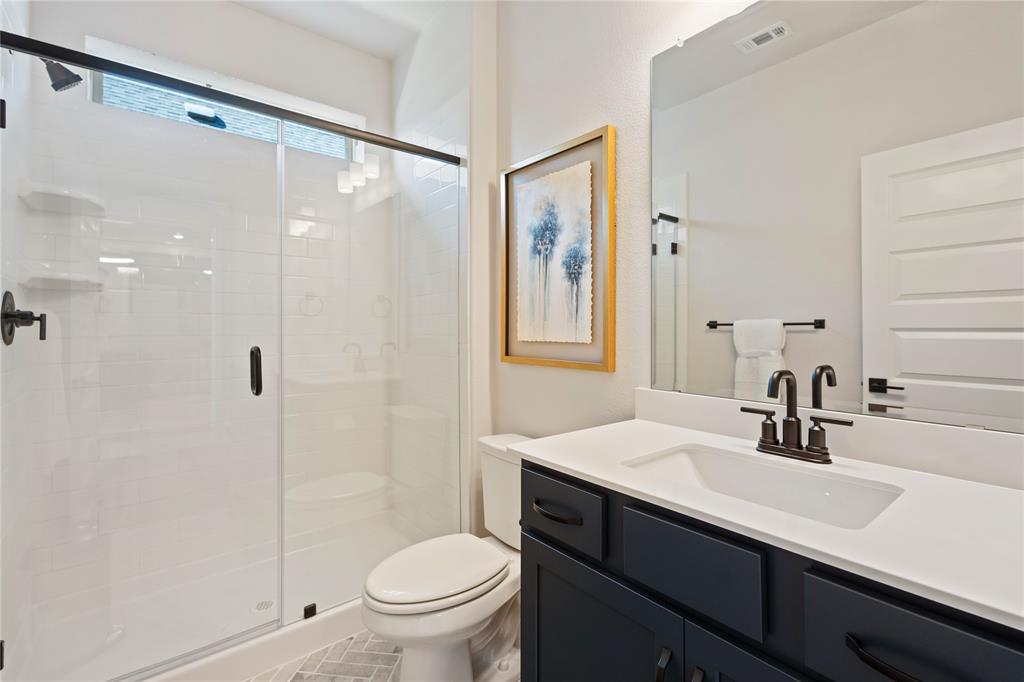 8717 Kentucky Derby Street Pilot Point, TX 76258 - Photo 14 of 18 a bathroom with a sink shower and a toilet