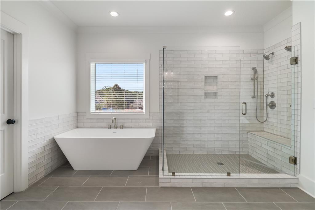 2113 Stonegate Way Monroe, GA 30656 - Photo 31 of 43 a bathroom with a bathtub and shower