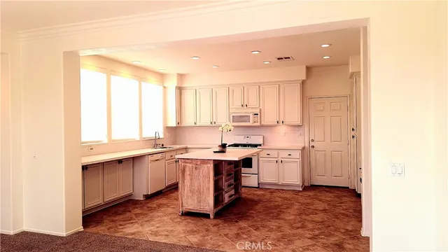 a kitchen with a sink cabinets and window