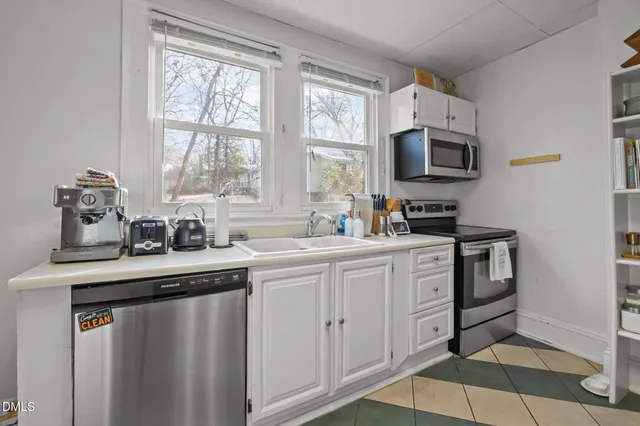 a kitchen with refrigerator and cabinets