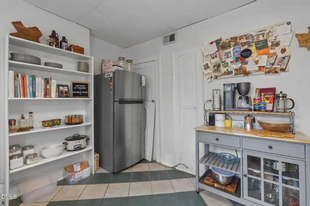 a view of a hallway with wooden floor and furniture
