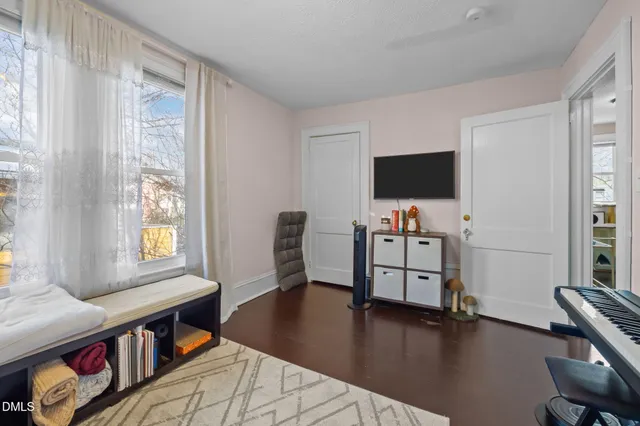 a bedroom with a bed and a view of kitchen