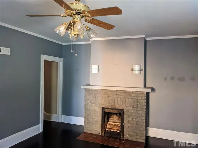an empty room with windows and fireplace