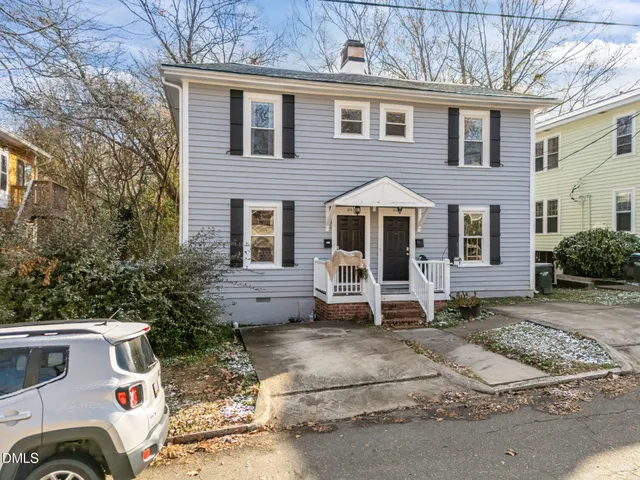 a view of a house with a yard and garage
