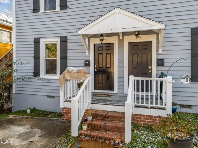 a front view of a house with glass windows and door