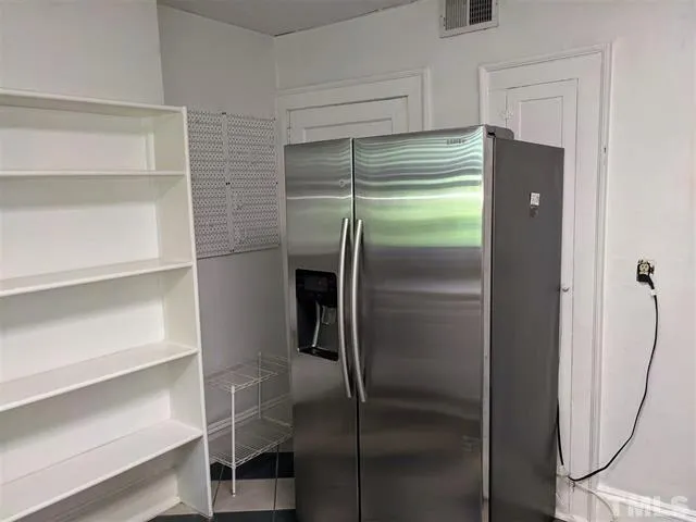 a refrigerator freezer sitting inside of a room