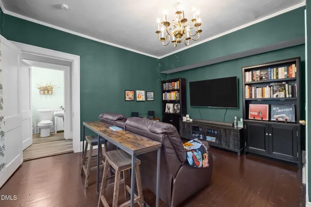 a view of a dining room with furniture and a chandelier