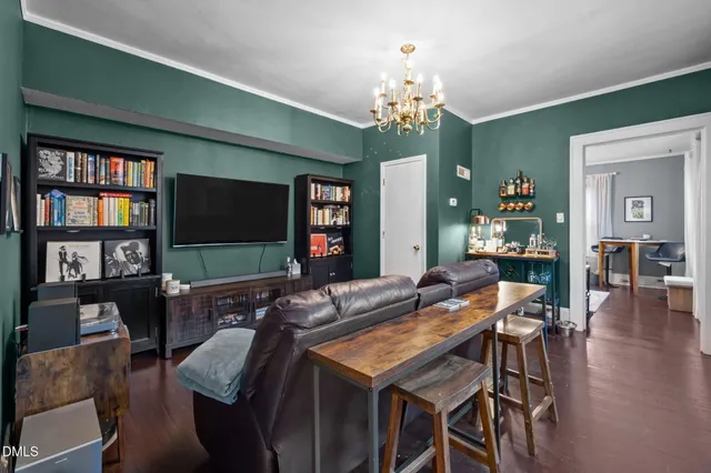 a living room with furniture and a chandelier