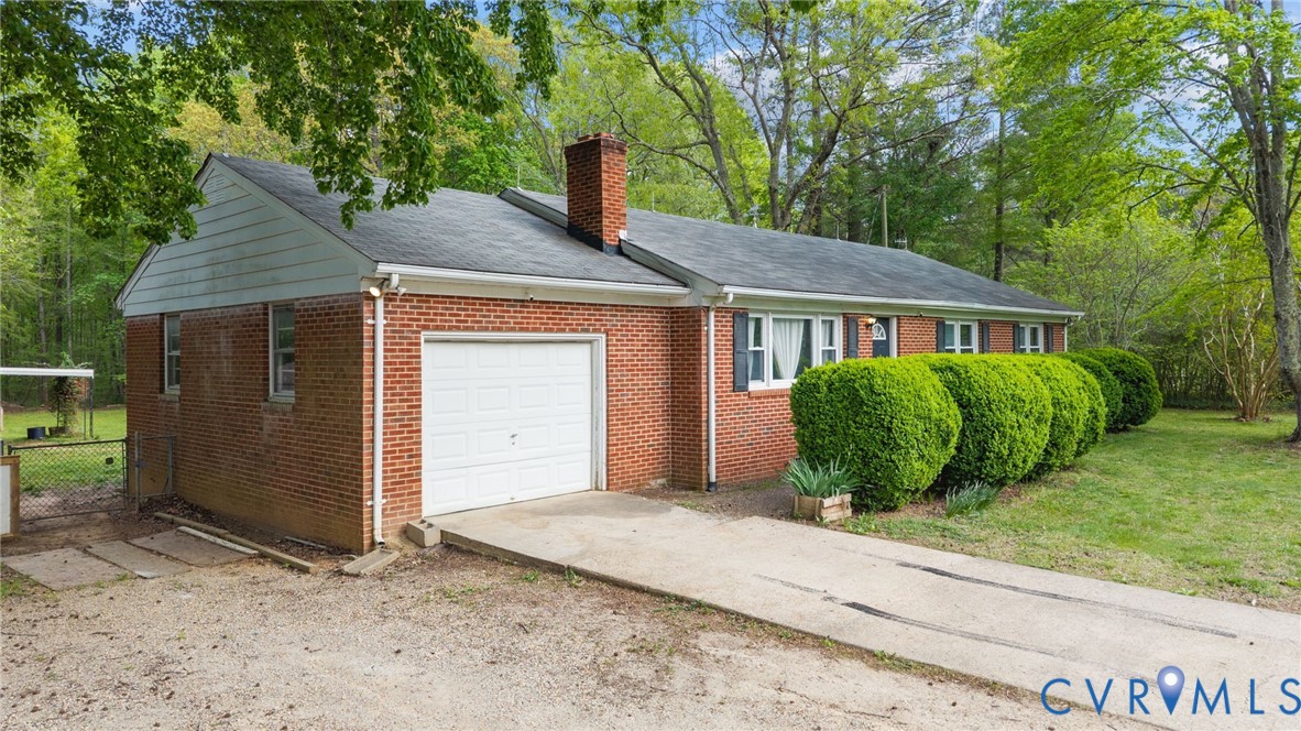 8141 Military Road Amelia Court House, VA 23002 - Photo 4 of 40 a front view of a house with garden