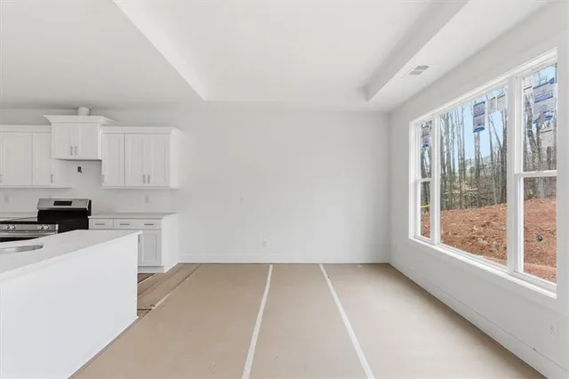 a kitchen with a sink a stove cabinets and white stainless steel appliances