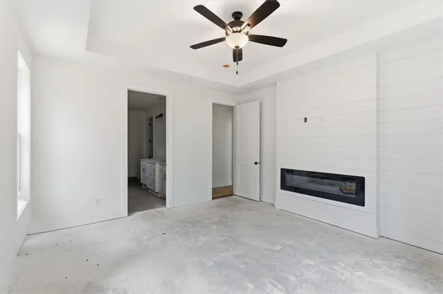 an empty room with closet and windows