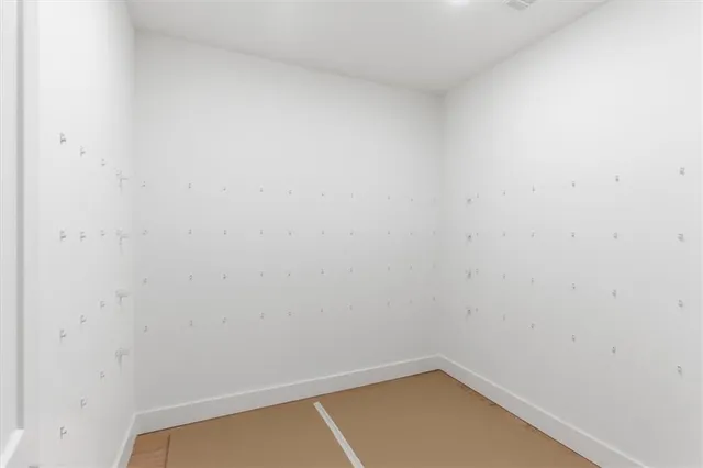 a view of a small room with wooden floor