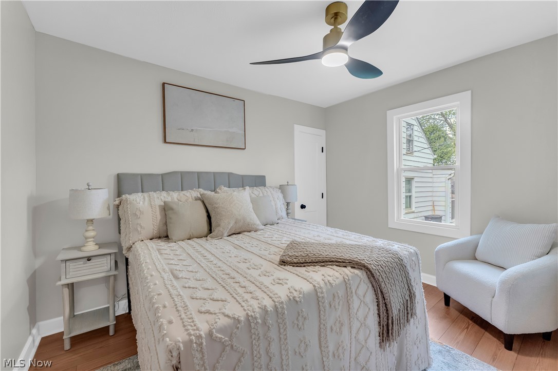 18155 Libby Road Maple Heights, OH 44137 - Photo 17 of 32 Spacious room featuring wood-finish flooring, light grey walls, and a contemporary ceiling fan with integrated lighting