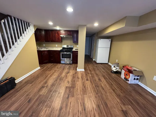 a kitchen with granite countertop wooden cabinets and stainless steel appliances