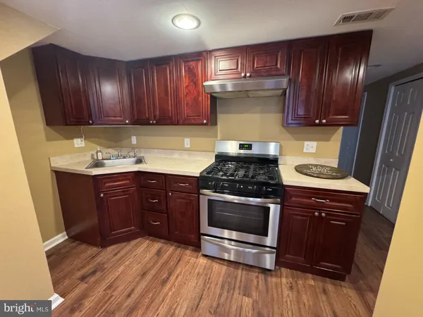 a room with wooden floor and gym equipment