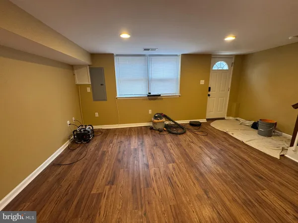 a room with a wooden floor and furniture