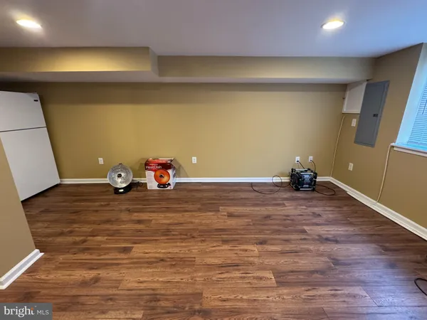a view of a room with wooden floor and entrance
