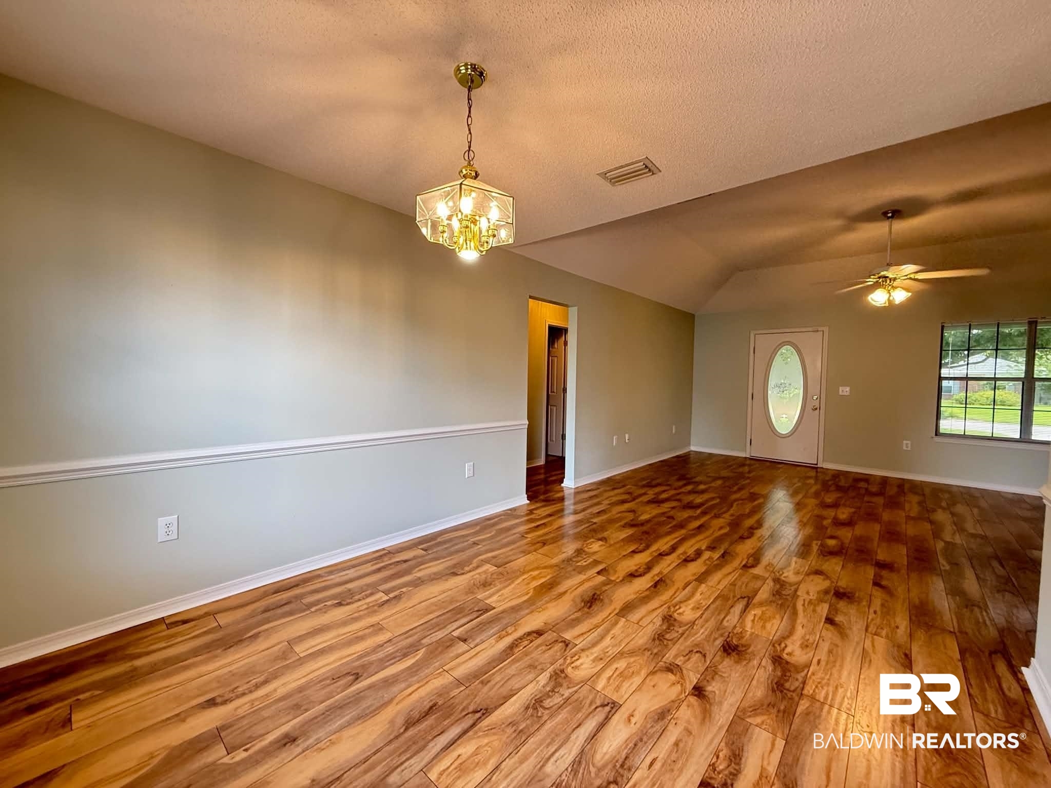 123 Pennbrooke Loop Foley, AL 36535 - Photo 18 of 49 Spacious interior with wood-finish flooring, vaulted ceilings, and a decorative chair rail molding