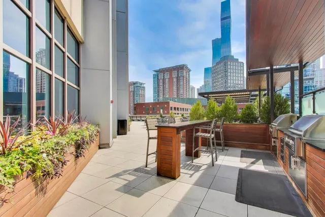a view of a patio with tables and chairs and potted plants