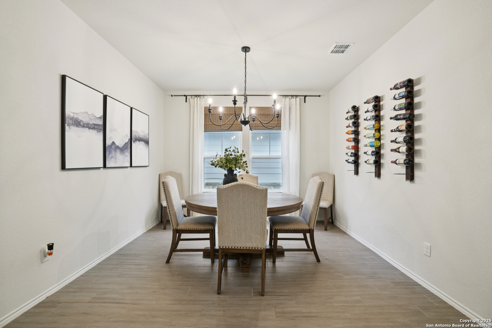 9028 Curling Post Schertz, TX 78154 - Photo 11 of 37 a dining room with furniture a chandelier and wooden floor