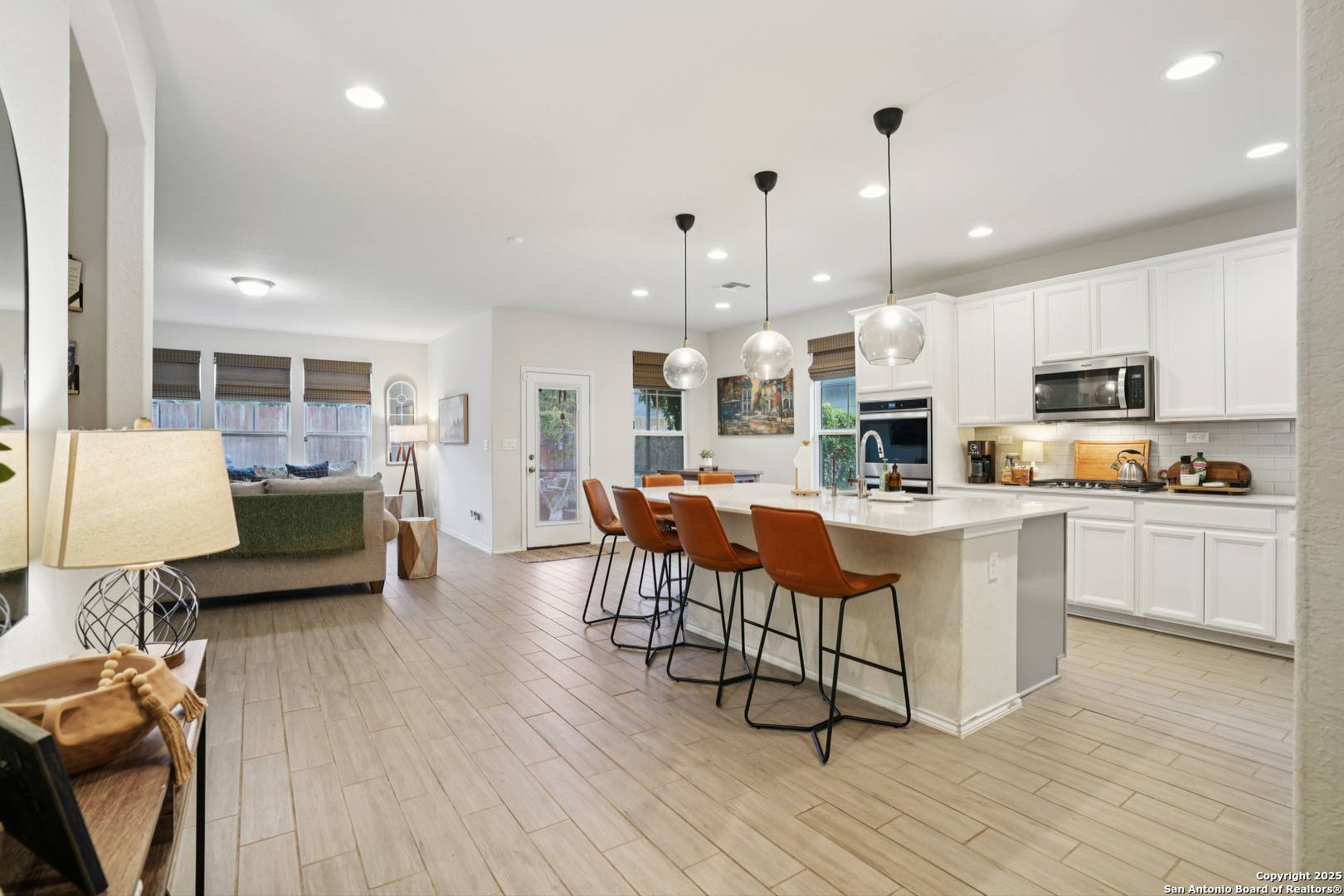 9028 Curling Post Schertz, TX 78154 - Photo 12 of 37 a kitchen with stainless steel appliances kitchen island granite countertop a stove a sink a microwave a center island and furniture