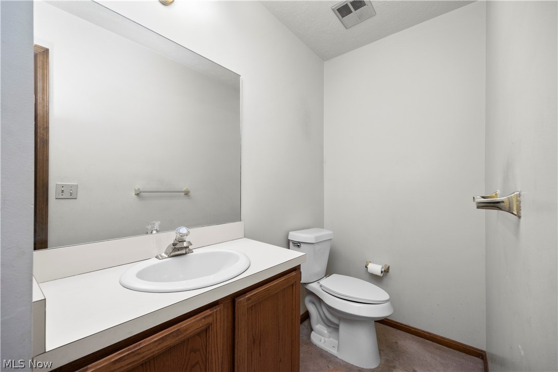 722 Jaycox Road Avon Lake, OH 44012 - Photo 21 of 48 Bathroom featuring a vanity with a white countertop, an integrated sink, and wood-finish cabinetry