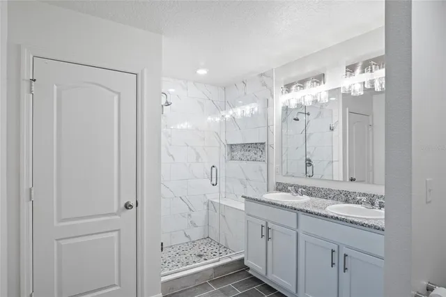 a bathroom with a double vanity sink mirror and double
