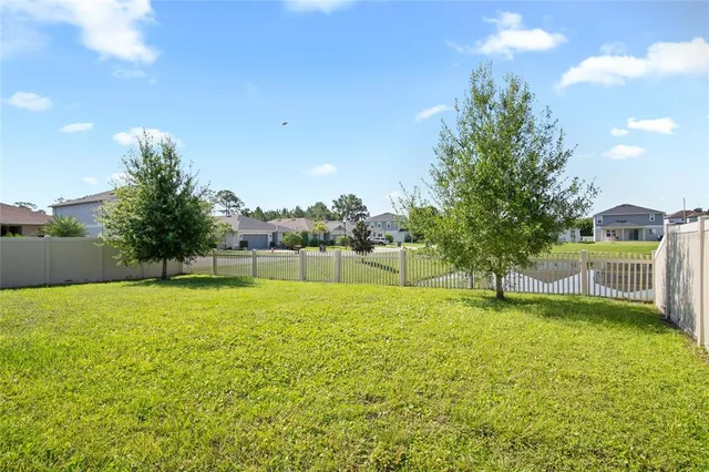 a swimming pool with trees in the background