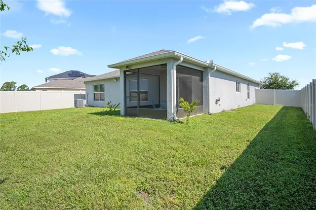 a view of a house with a yard and a porch