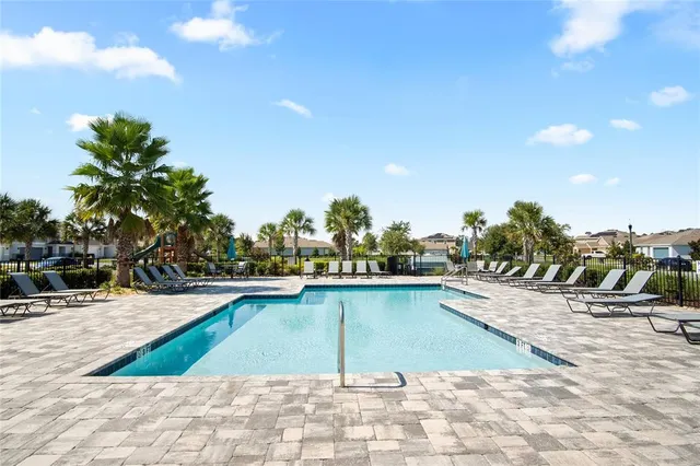a view of swimming pool with outdoor seating and plants