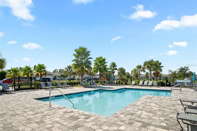 a view of a swimming pool with a lawn chairs