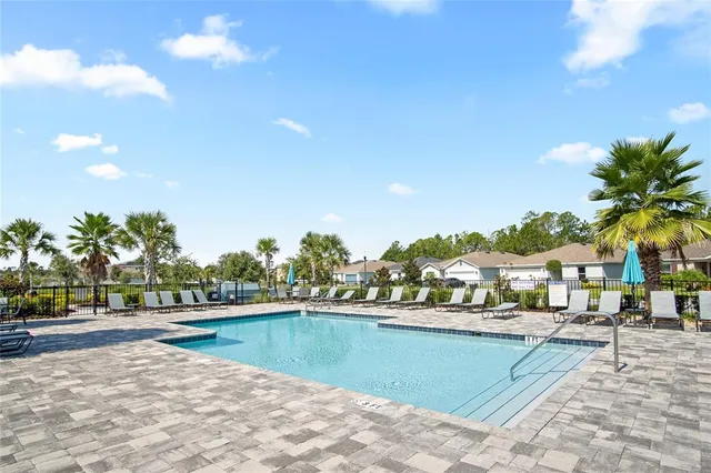a view of swimming pool with outdoor seating and yard in the back
