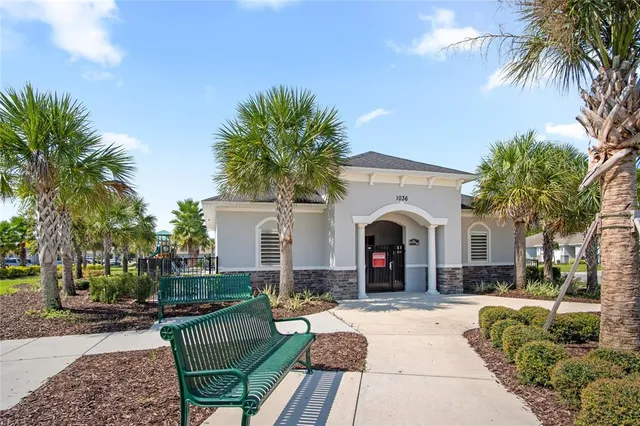 a view of a house with backyard and swimming pool